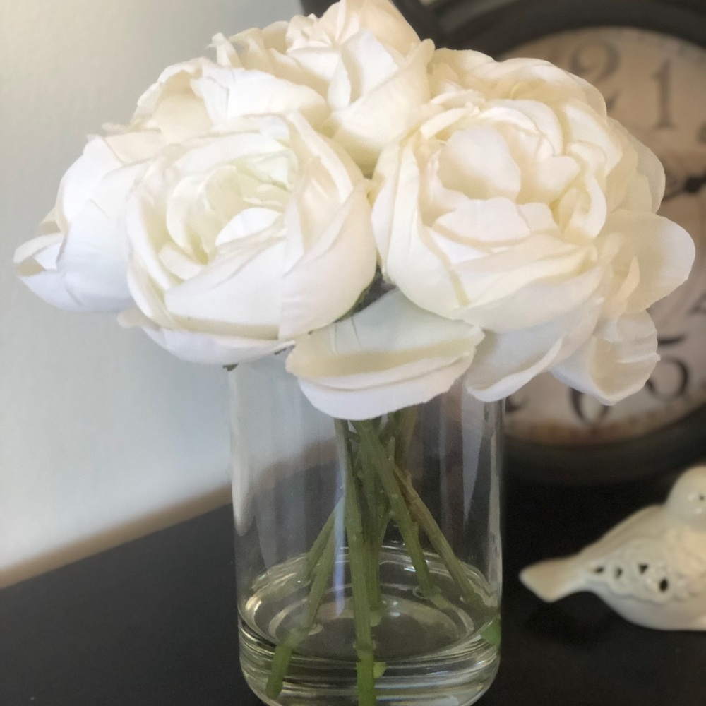 Artificial peony bouquet in glass vase